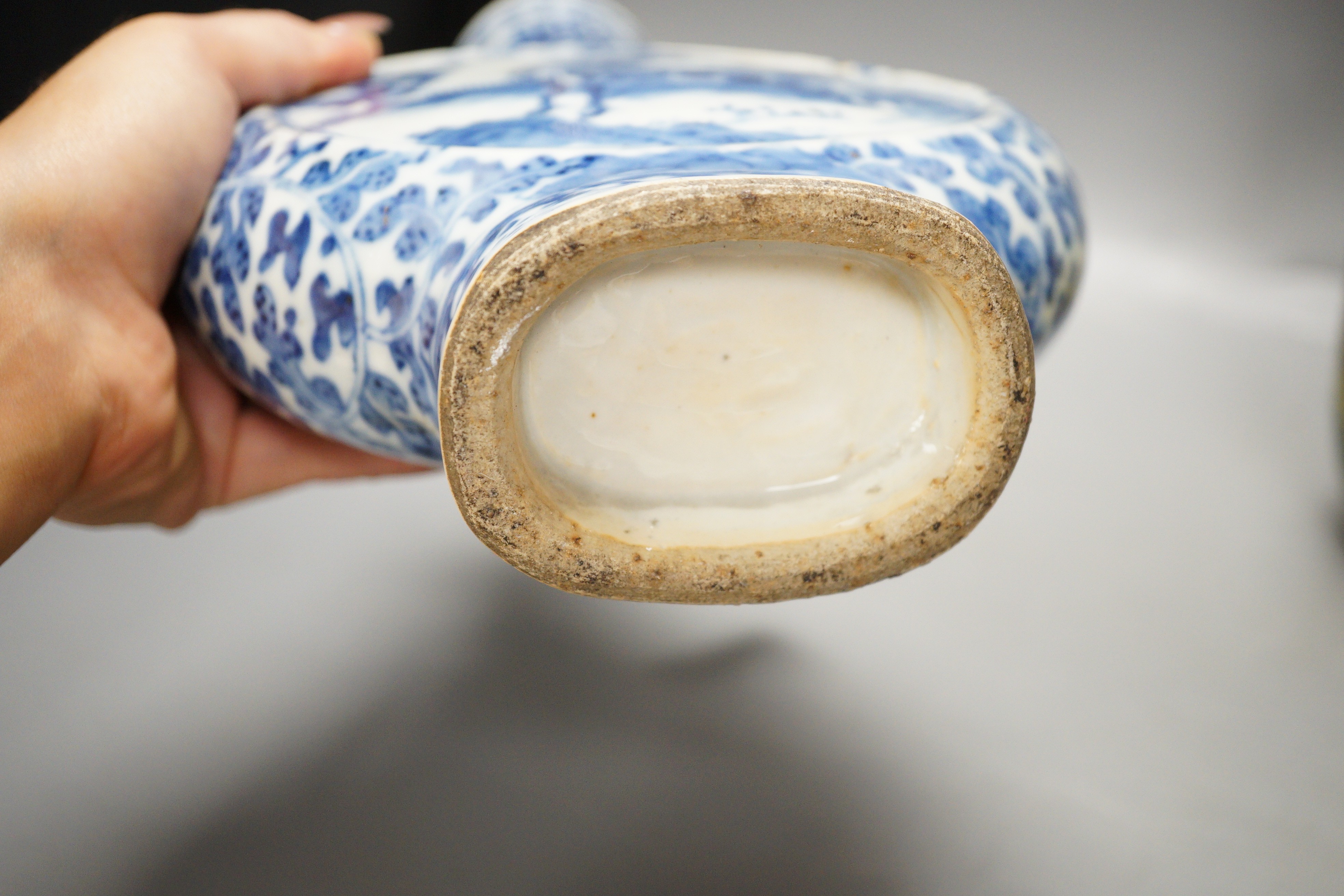 A Chinese famille verte vase and cover, a yellow ground ‘soldiers’ vase, a blue and white moonflask and a similar’dragon’ sleeve vase, all late 19th/early 20th century, Tallest 33cm